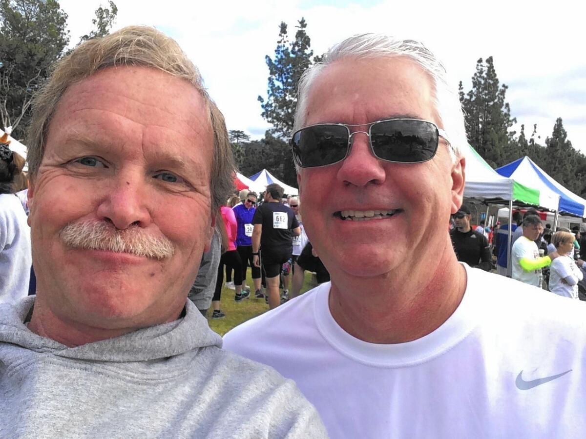 Chris Erskine, left, takes a selfie with buddy Gary Johnson at a 5K turkey trot.