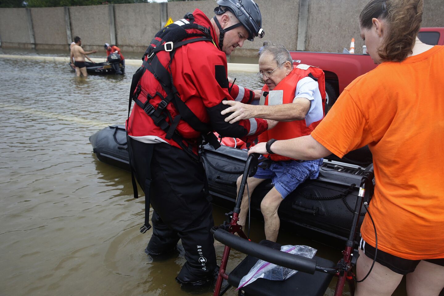 A Houston police officer helps Frank Andrews, 74, into his walking chair after rescuing him from his flooded home in the Braeswood Place neighborhood, southwest of Houston, on Sunday.