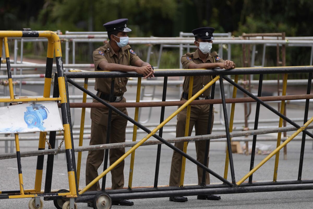 Police officers man a barricade at the entrance to the Sri Lankan parliament in Colombo, Sri Lanka, Tuesday, May 17, 2022. (AP Photo/Eranga Jayawardena)