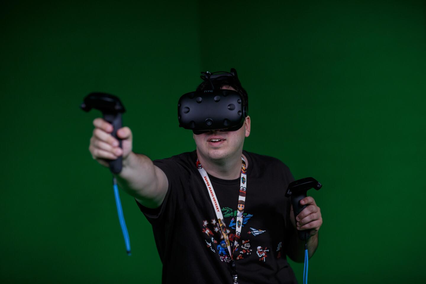 Christopher Galloway tries out a wireless virtual reality unit for a first person shooter game at E3 in Los Angeles.
