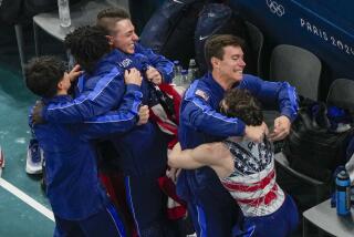 Members of the U.S. team react after winning the bronze medal during the Olympic men's gymnastics team finals Monday