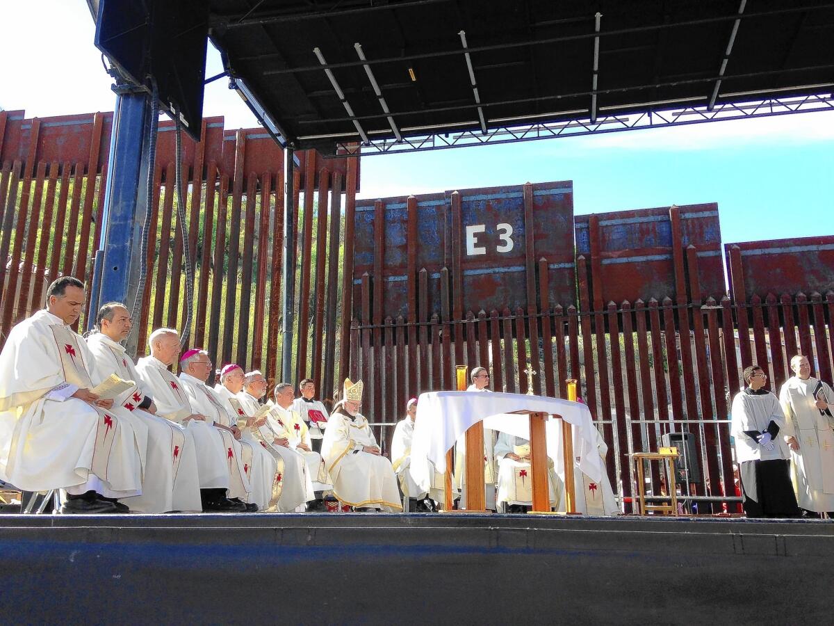 Catholic leaders gather at the border fence in Nogales, Ariz., to celebrate a Mass for people in Mexico and the U.S.