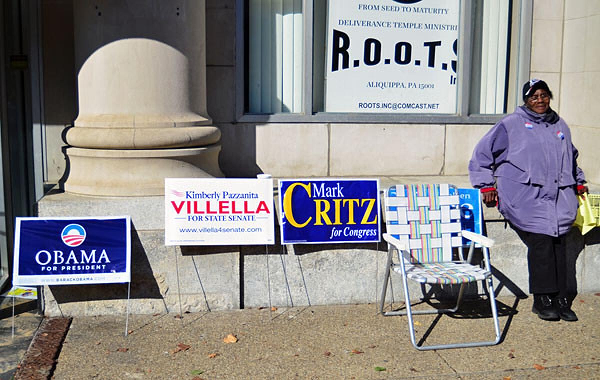 Poll worker Ruby Slappy waits to talk to voters outside of the Renaissance Center on Franklin Avenue in Aliquippa, Pa.