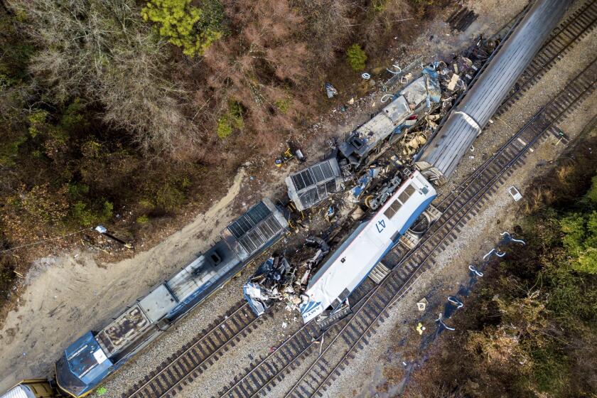 An aerial view of the site of an early morning train crash Feb. 4, 2018, between an Amtrak train, bottom right, and a CSX freight train, top left, in Cayce, S.C.