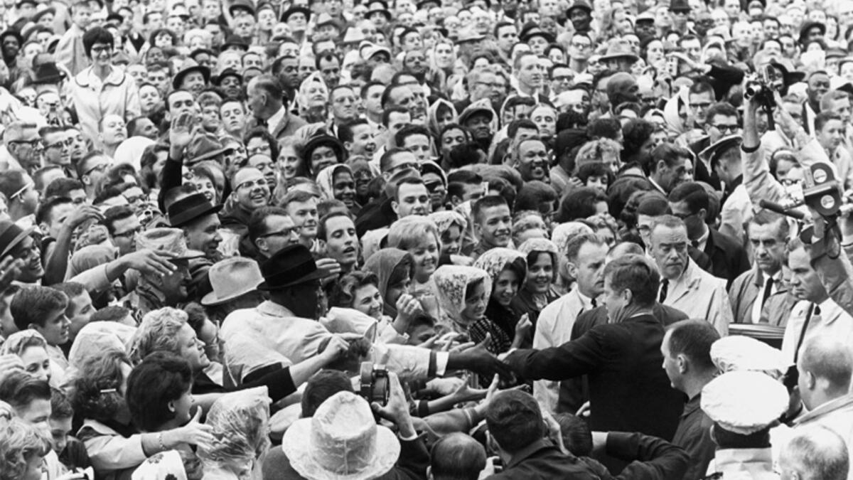 President John F. Kennedy greets a large crowd at a rally in Fort Worth, Texas, on the morning of Nov. 22, 1963, the day of his assassination. Museums and libraries across the country are marking Kennedy's 100th birthday.