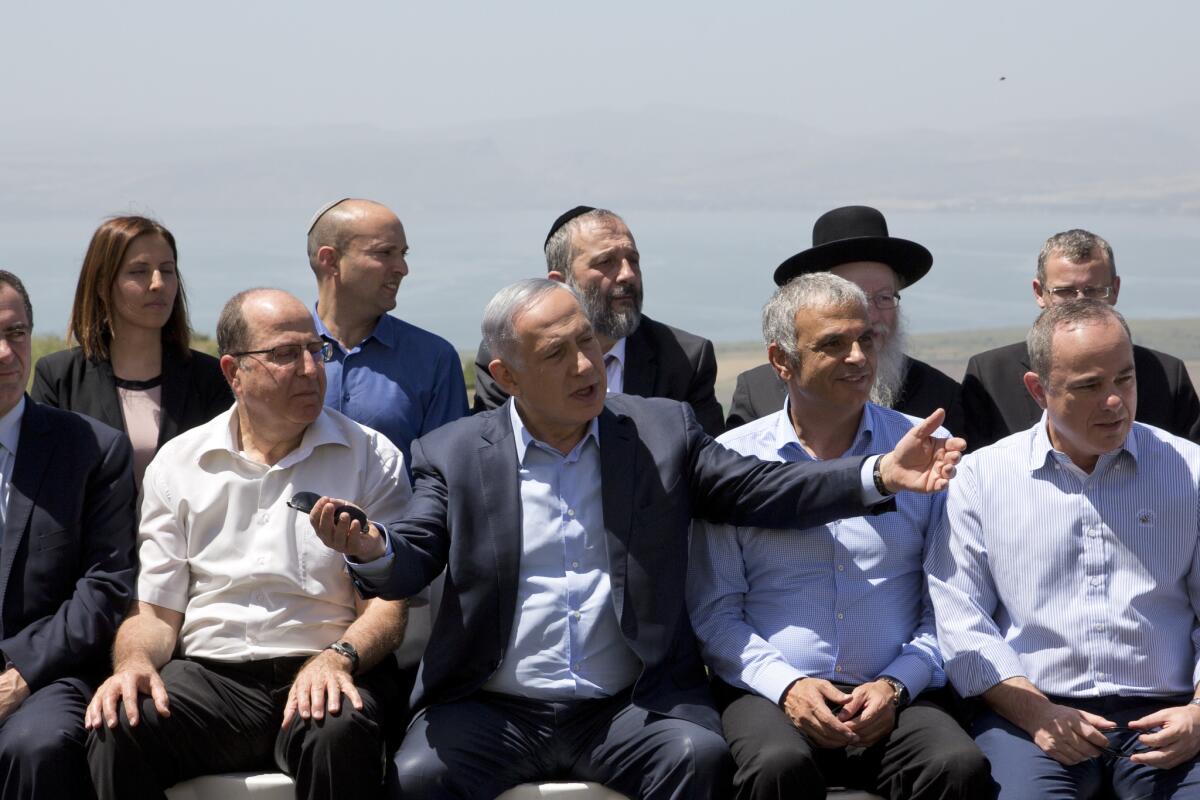 Israeli Prime Minister Benjamin Netanyahu, center, with ministers before a Cabinet meeting in the Israeli-controlled Golan Heights in April.