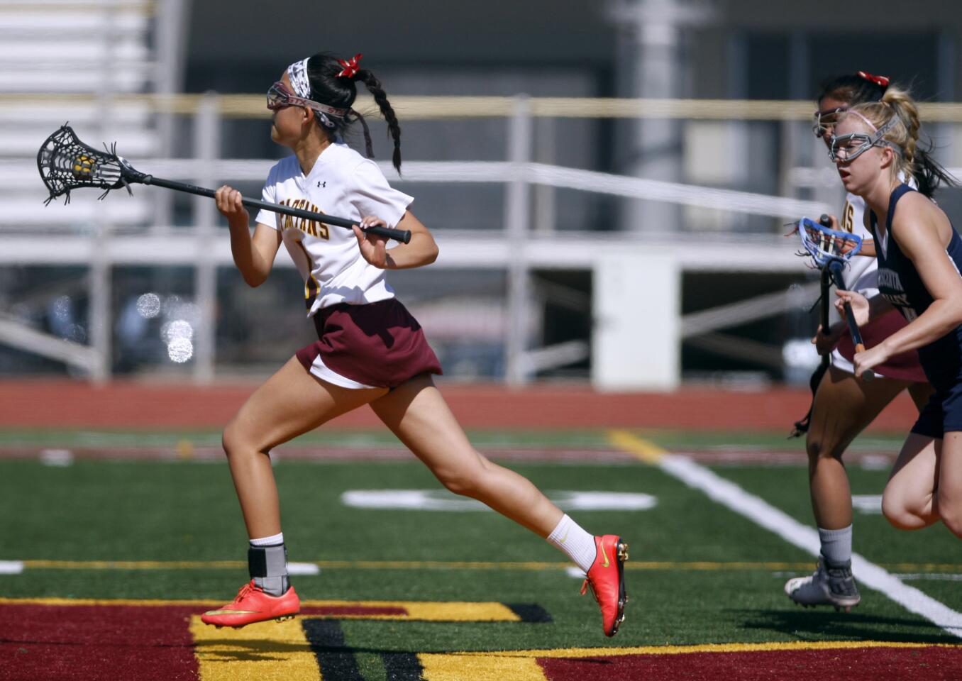 La Cañada High School girls lacrosse player #5 Diane Lee runs down the field in game vs. Crescenta Valley High School, at home in La Cañada Flintridge on Friday, April 14, 2017.