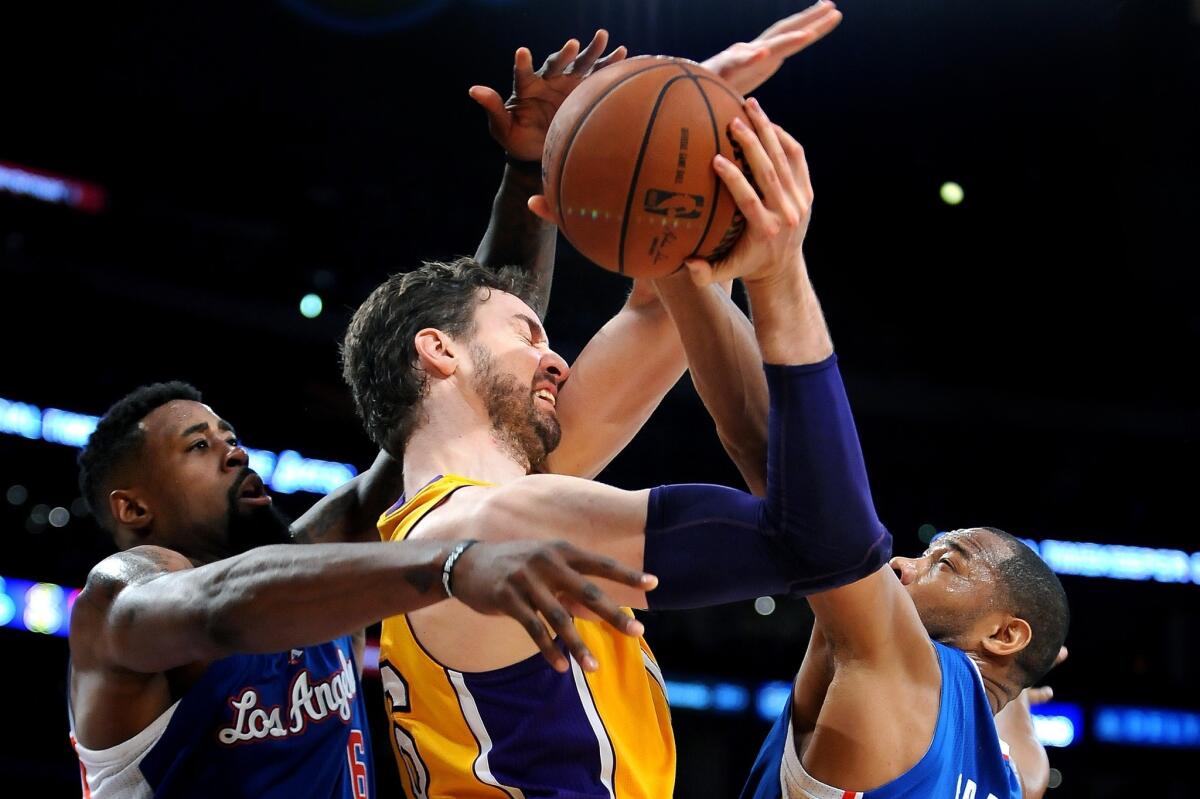 Clippers center DeAndre Jordan, left, and forward Willie Green trap Lakers power forward Pau Gasol in the first half Thursday night at Staples Center.
