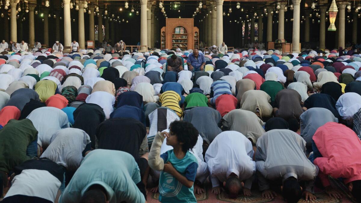 Muslim Egyptians pray at a mosque in central Cairo during Eid al-Fitr, before the Egypt-Uruguay match.