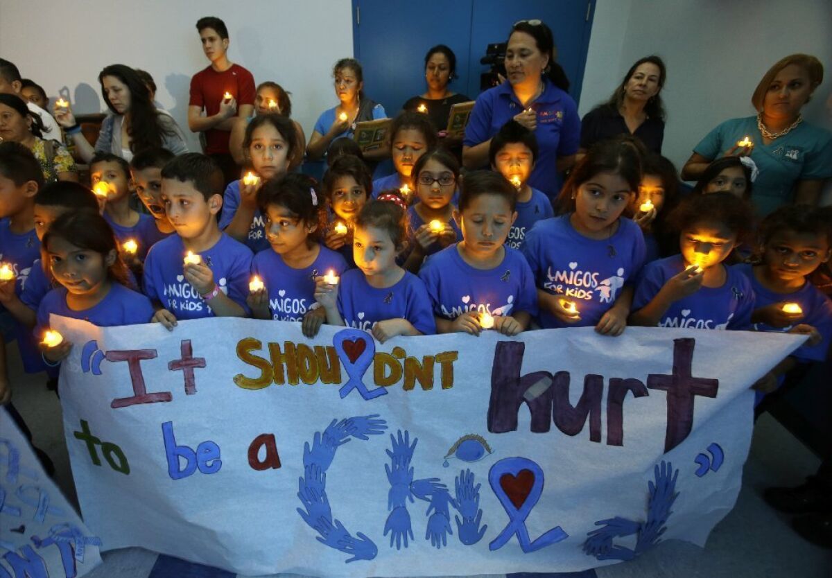 Children in Miami participate in a candlelight vigil commemorating National Child Abuse Prevention Month. A new study estimates that 12.5% of American kids suffer a documented case of abuse or neglect before turning 18.