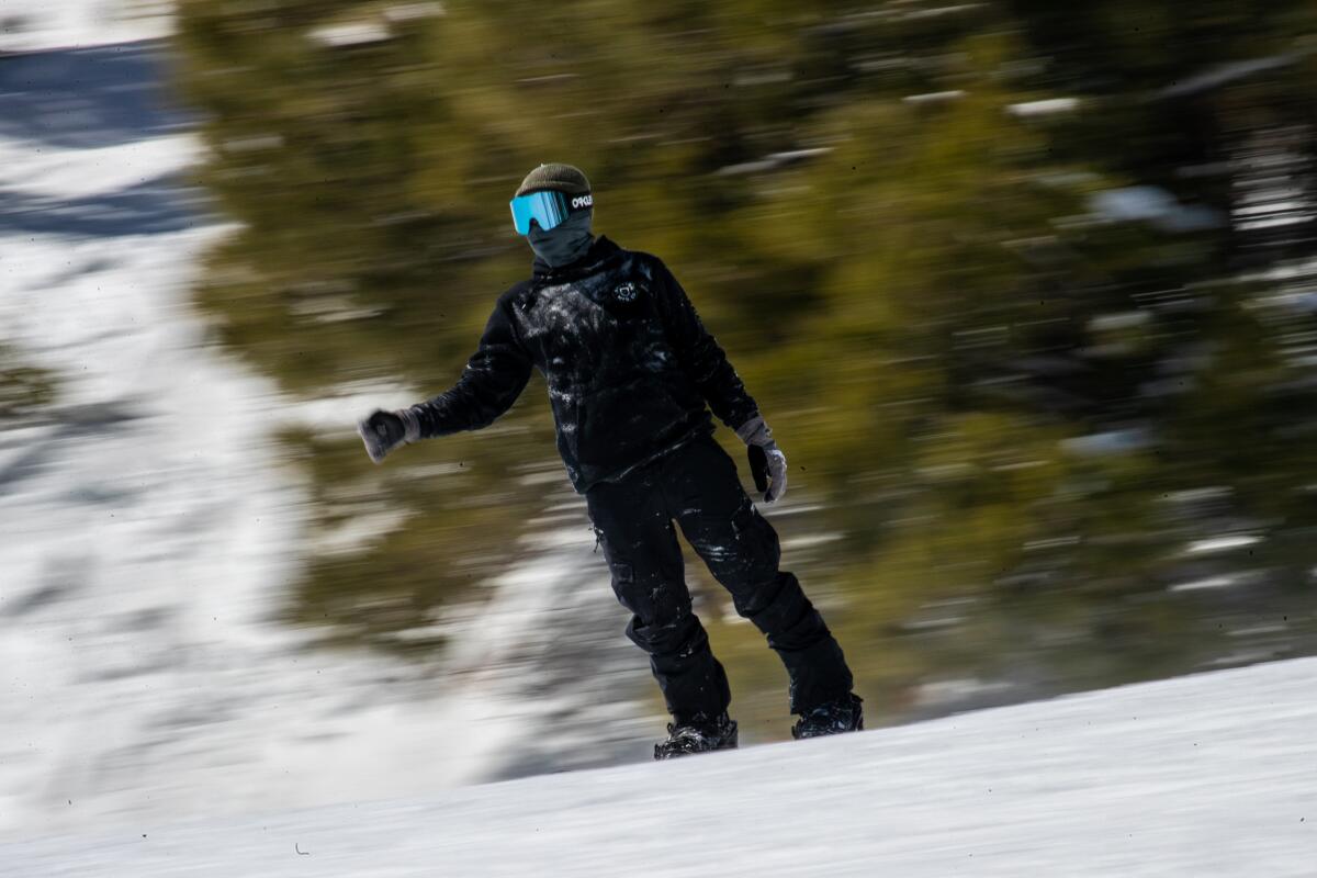 A snowboarder glides down the slopes at Big Bear Mountain Resort.