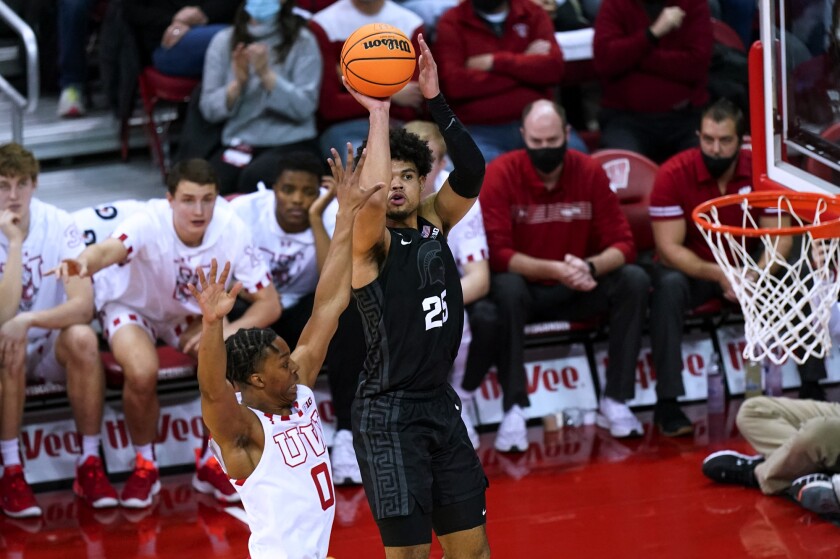 Michigan State's Malik Hall (25) shoots against Wisconsin's Jahcobi Neath (0) during the first half of an NCAA college basketball game Friday, Jan. 21, 2022, in Madison, Wis. (AP Photo/Andy Manis)