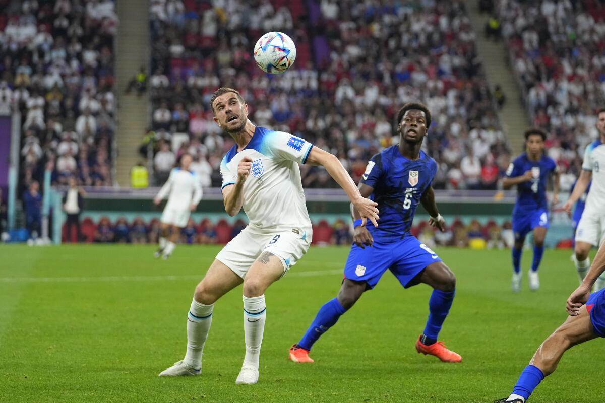 England's Jordan Henderson, left, fights for the ball against the United States' Yunus Musah on Friday.