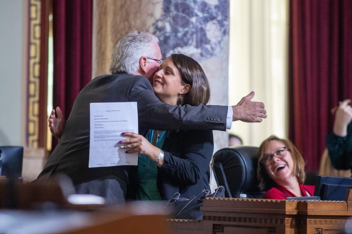 Imelda Padilla hugs Paul Krekorian 