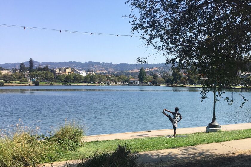 After being sealed off to prevent overcrowding over the weekend, Oakland's Lake Merritt reopened Monday, attracting a few people out for some exercise on a sunny day.