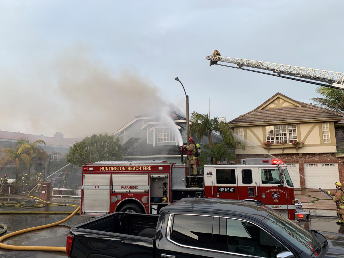 Huntington Beach firefighters responded Tuesday to a three-alarm house fire at a Trinidad Island home off Venture Drive.