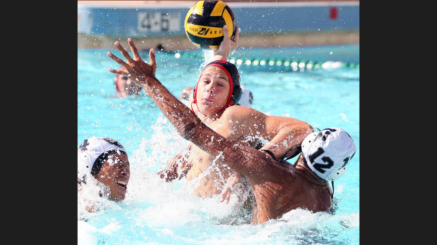 Glendale's Leo Grossman shoots and scores against Arroyo Valley's Giovani Ochoa and German Barrazza in a non-league boys' water polo match at Glendale High School on Thursday, September 21, 2017.
