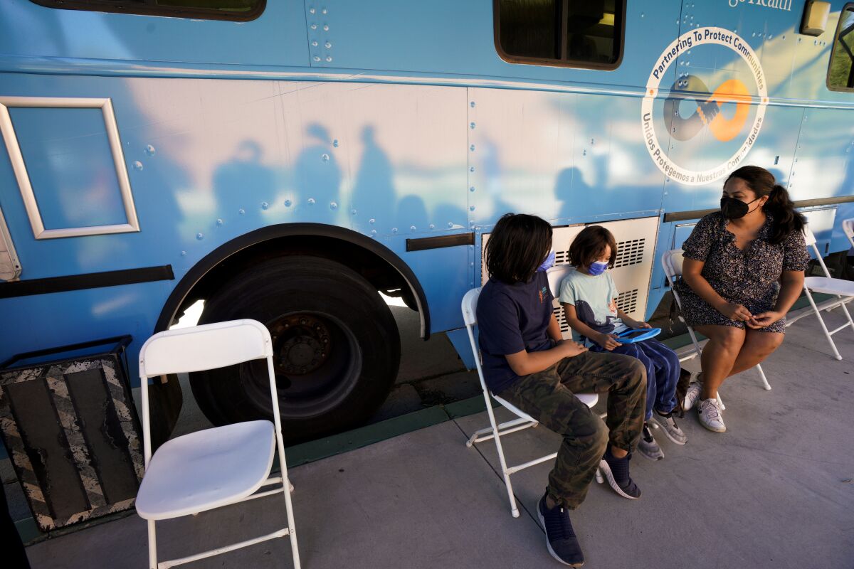  Tara Tafoya took two sons to the UC San Diego Health van at Sa Diego Unified district office 