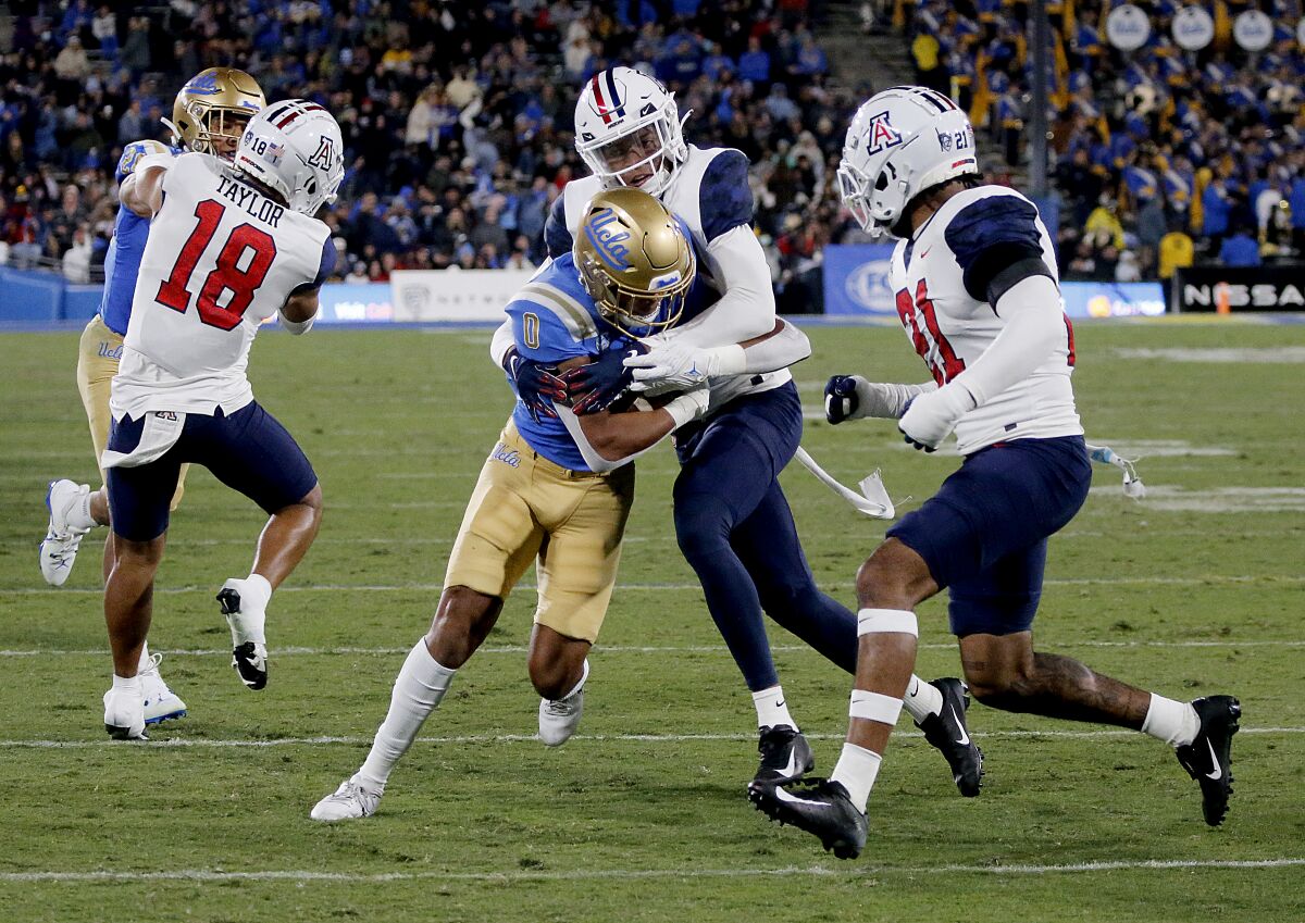 UCLA wide receiver Kam Brown is tackled after making a catch during the first half Saturday.