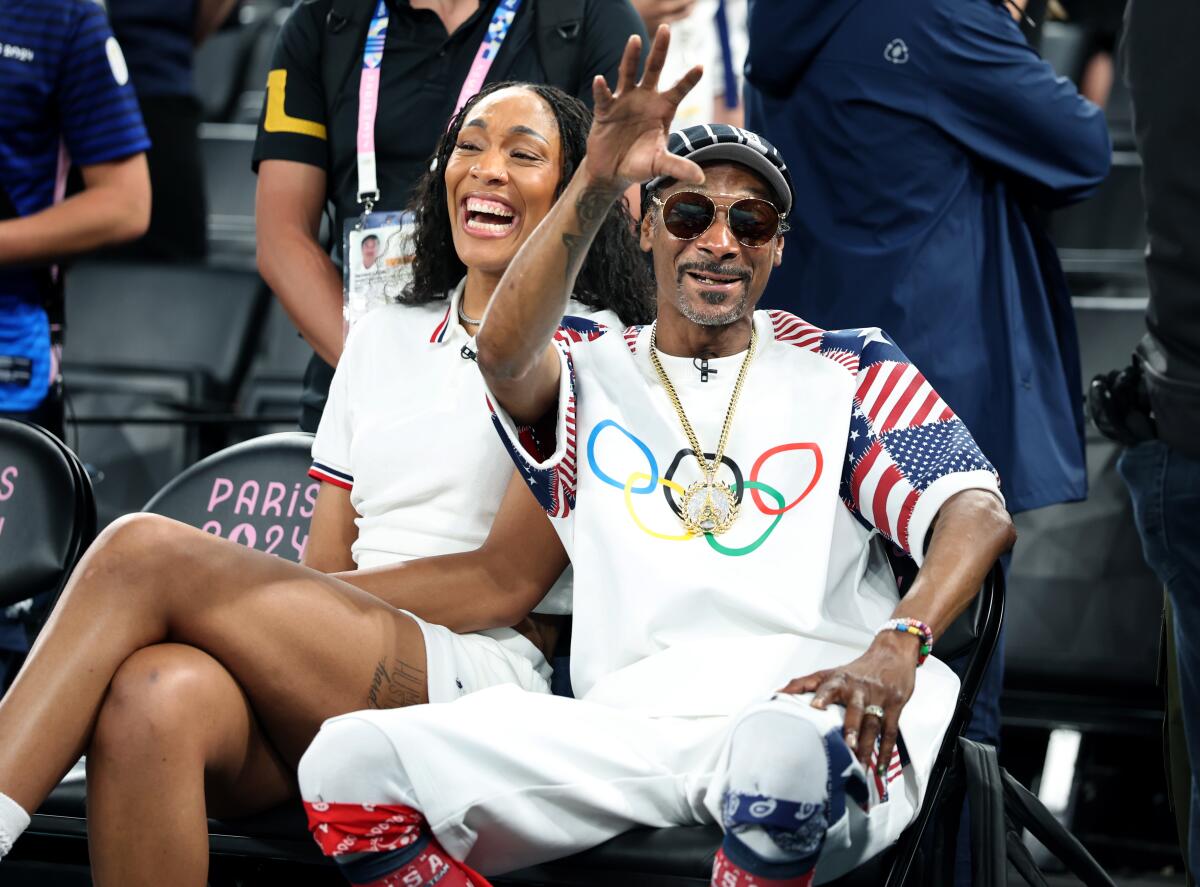 USA women's basketball player A'ja Wilson laughs with rapper Snoop Dogg, a fixture of the Paris Olympics coverage on NBC.