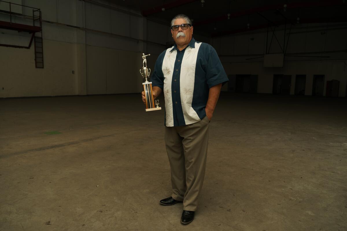 Tony "The Tiger" Espinosa holds a boxing trophy he left behind after his release from prison 30 years ago.