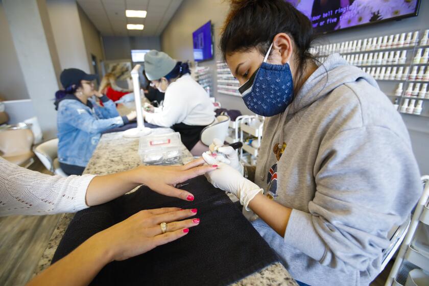 On Wednesday March 18, 2020, Crystal Diaz at the Posh & Polished Nail Lounge in Barrio Logan worked on a customer's finger nails. Though business has been slow, the lounge still gets walk in customers.