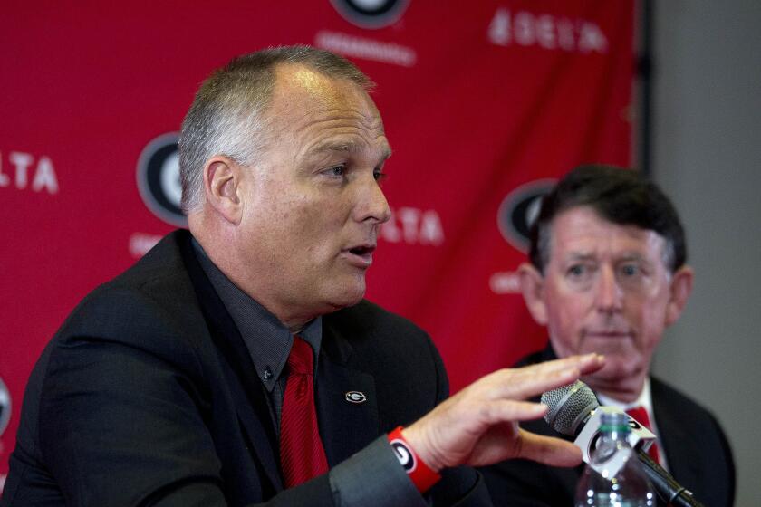 Georgia Coach Mark Richt speaks as Athletic Director Greg McGarity looks on during a news conference to discuss Richt's departure from the school.