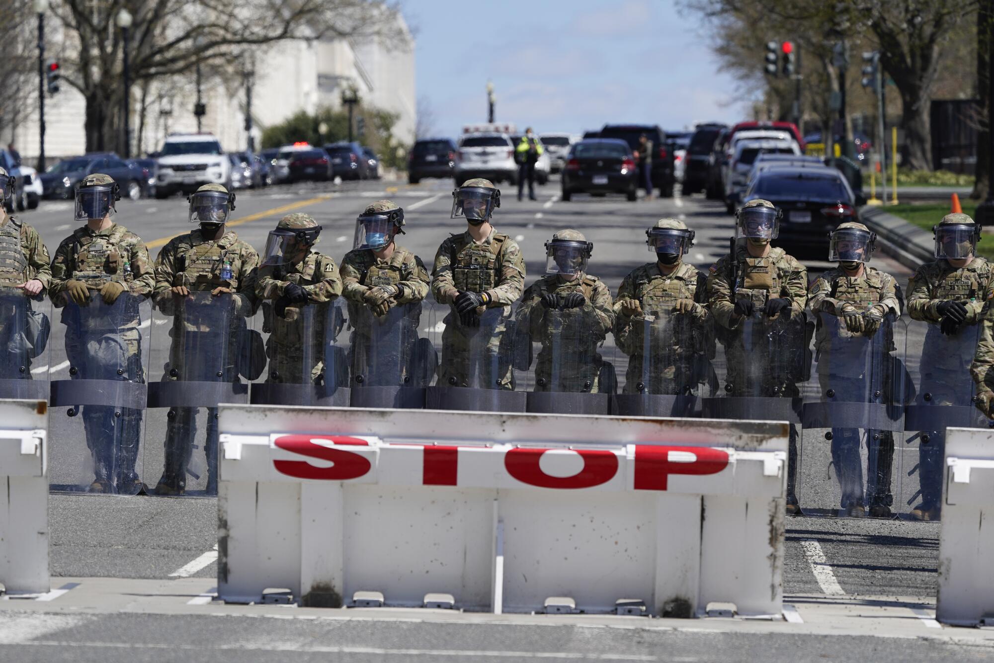Troops stand guard near the scene.
