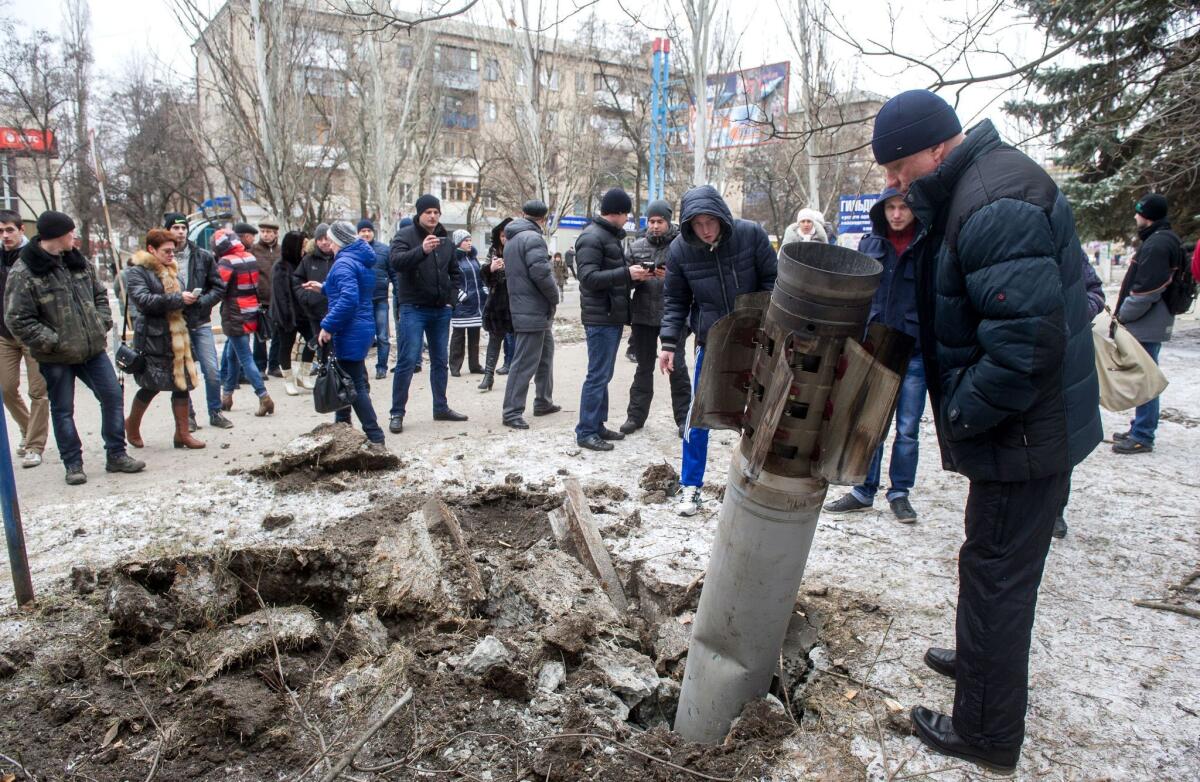 An unexploded missile is embedded in a street in the eastern Ukrainian city of Kramatorsk on Feb. 10.