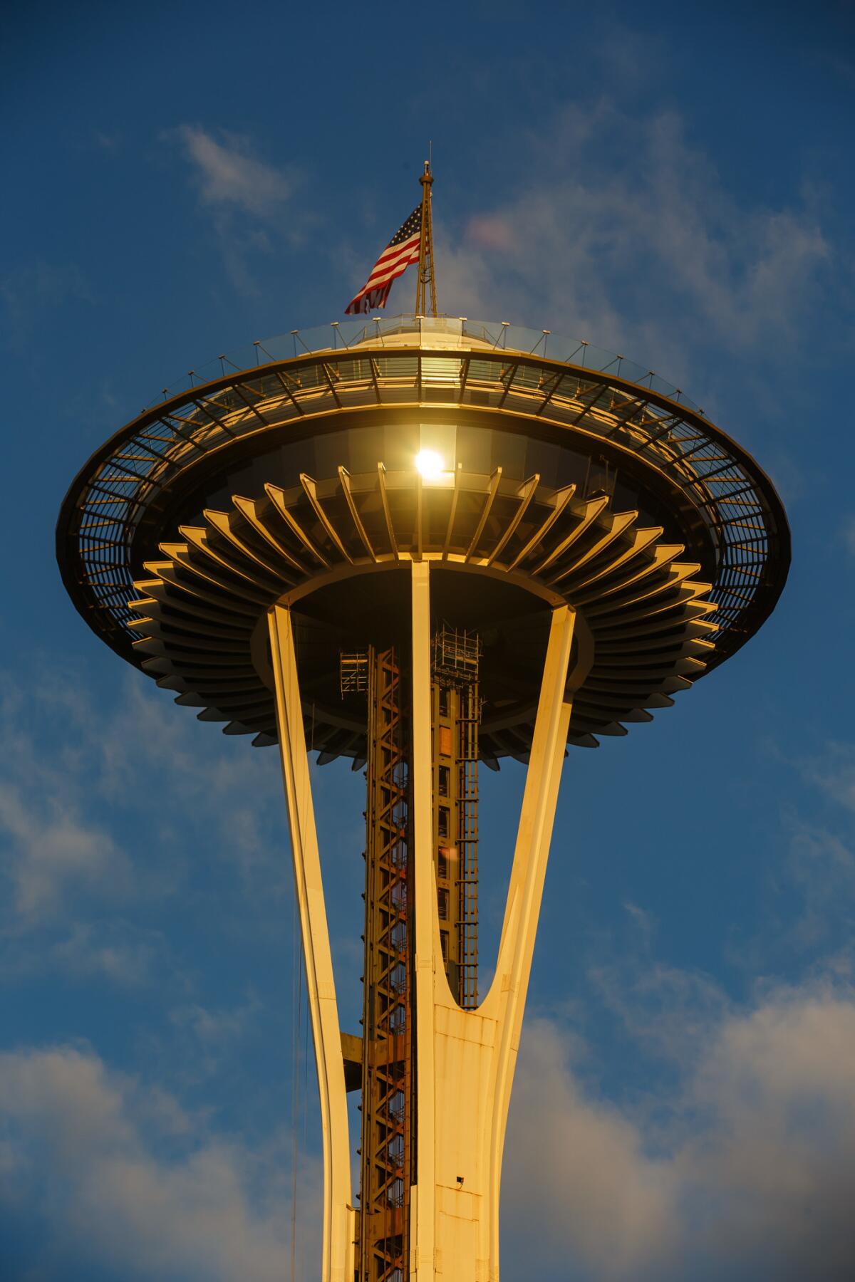 Sunrise bathes the Space Needle in a warm glow, in Seattle, Wash.