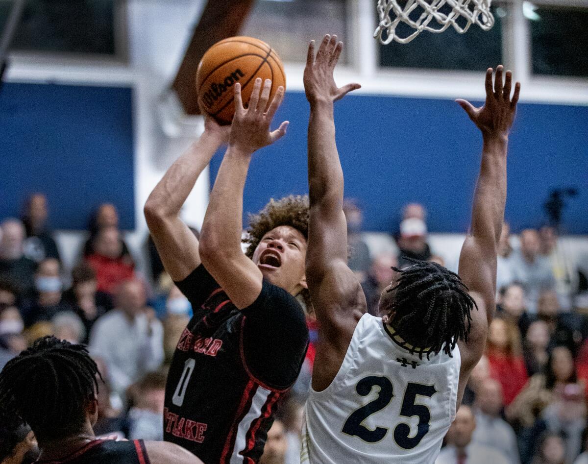 Harvard-Westlake High School point guard Trent Perry attempts a layup over Notre Dame's Mercy Miller.