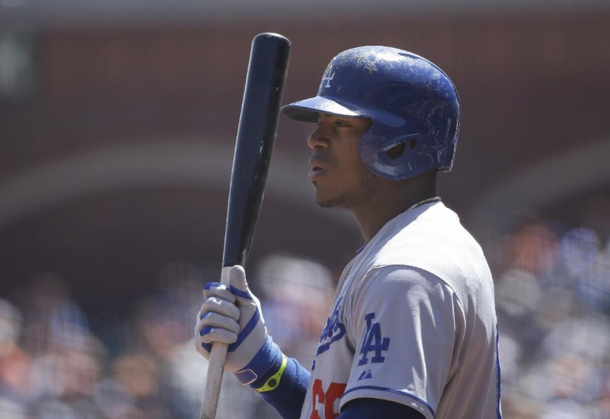 The Dodgers' Yasiel Puig is seen earlier this week standing in the on-deck circle during a game against the Giants in San Francisco. The outfielder has declined to comment on a story in Los Angeles Magazine reporting his harrowing journey from the Cuba to Mexico and ultimately the U.S.