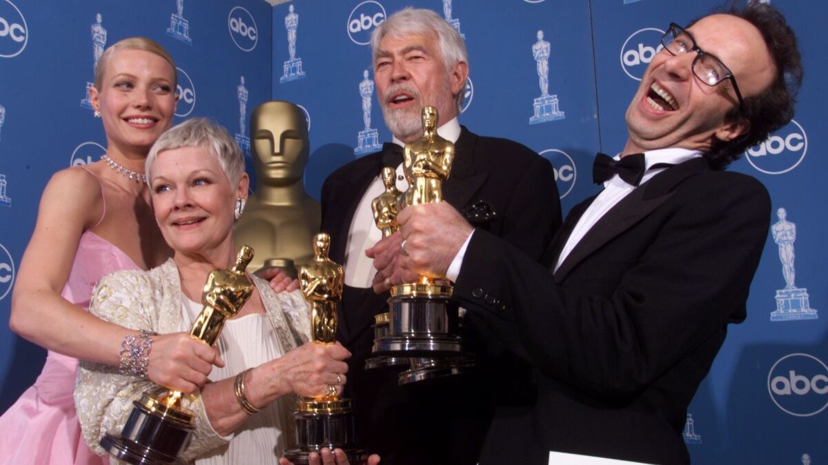 Gwyneth Paltrow, left, Judi Dench, James Coburn and Roberto Benigni back stage at the Academy Awards.