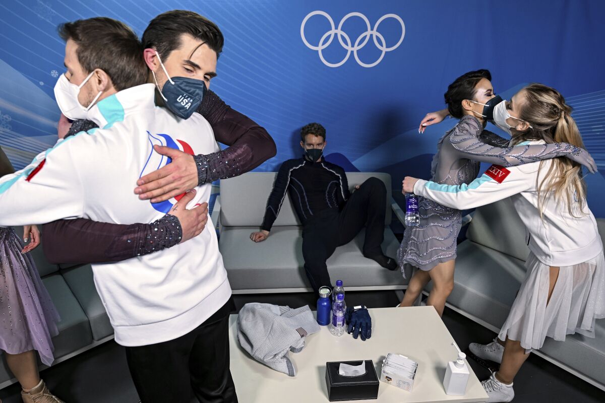From left, Nikita Katsalapov of the Russian Olympic Commitee, Zachary Donohue of the U.S., Evan Bates of the U.S., Madison Chock of the U.S., and Victoria Sinitsina of the Russian Olympic Committee are seen in the Green Room after competing in the ice dance figure skating at the 2022 Winter Olympics, Monday, Feb. 14, 2022, in Beijing. (Antonin Thuillier/Pool Photo via AP)