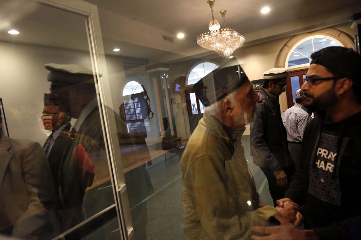 Members of the Baitul Hameed Mosque in Chino gather before a prayer service held by the Los Angeles Ahmadiyya Muslim Community at the mosque on Thursday, the day after the San Bernardino attack. The mosque will host a blood drive on Sunday.