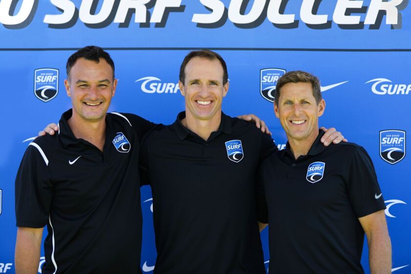 Drew Brees (center) pictured with Surf Sport's National Sporting Director Josh Henderson and CEO Brian Enge