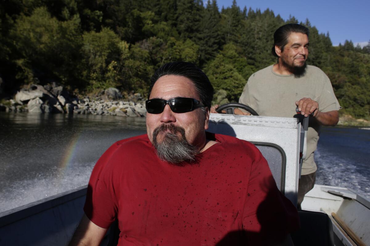 Since he was a young boy, Nick McCovey has set out gill nets in his ancient family fishing hole. Now fishing the river has never been harder. Above McCovey pilots his boat with Albert "Bubba" Markussen.