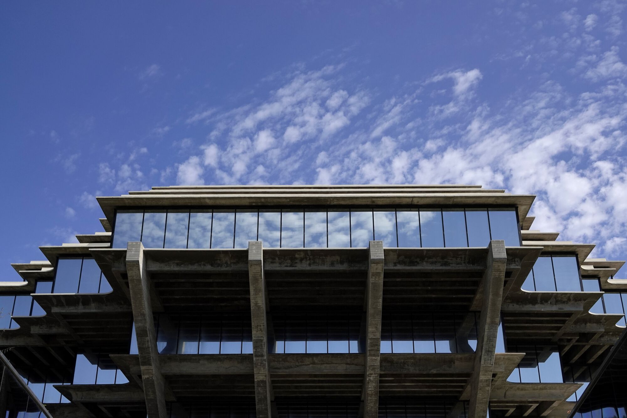 Clouds are reflected in the Geisel Library windows at UC San Diego in August.