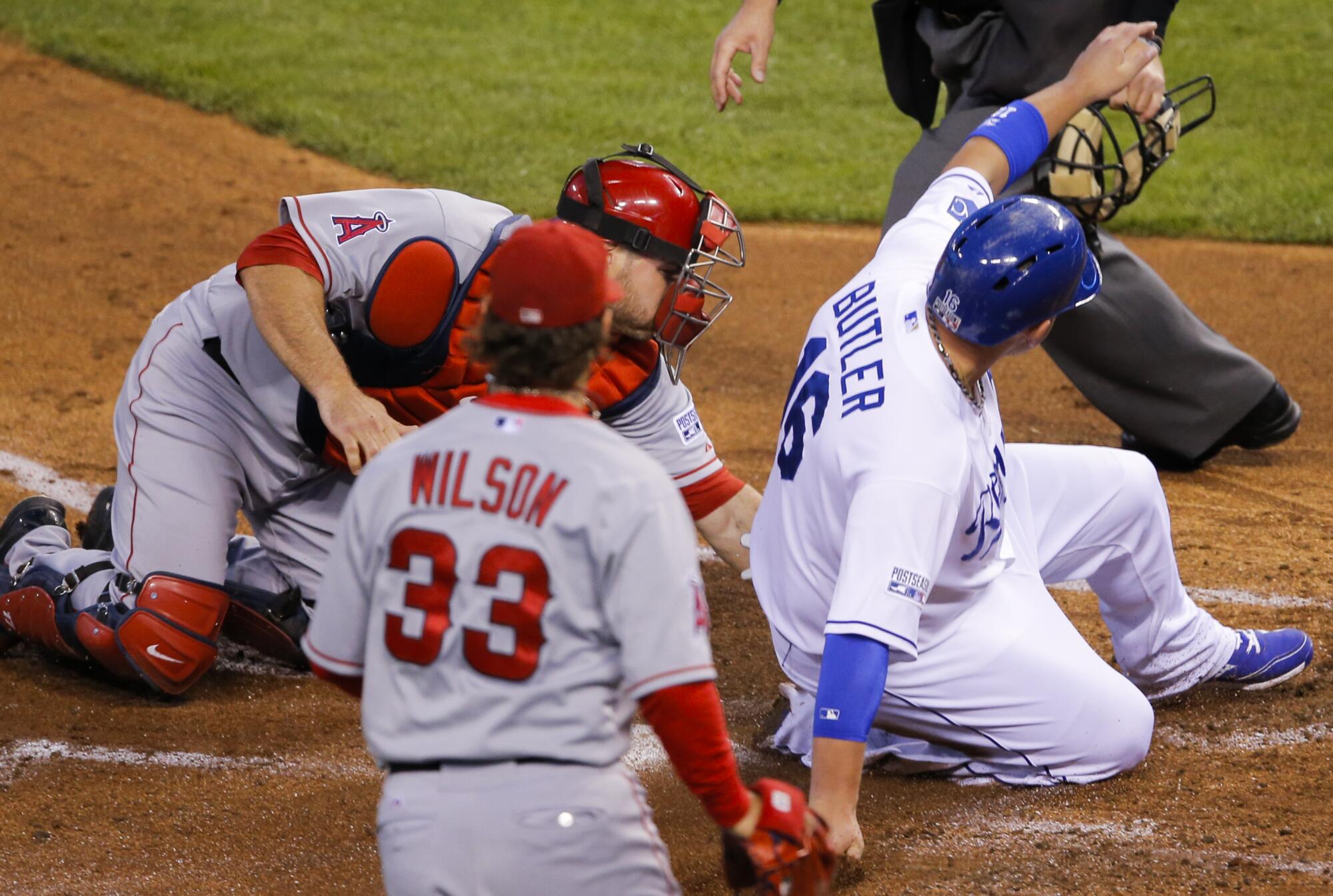Billy Butler of the Kansas City Royals beats the tag of Angels catcher Chris Iannetta during a 2014 playoff game.