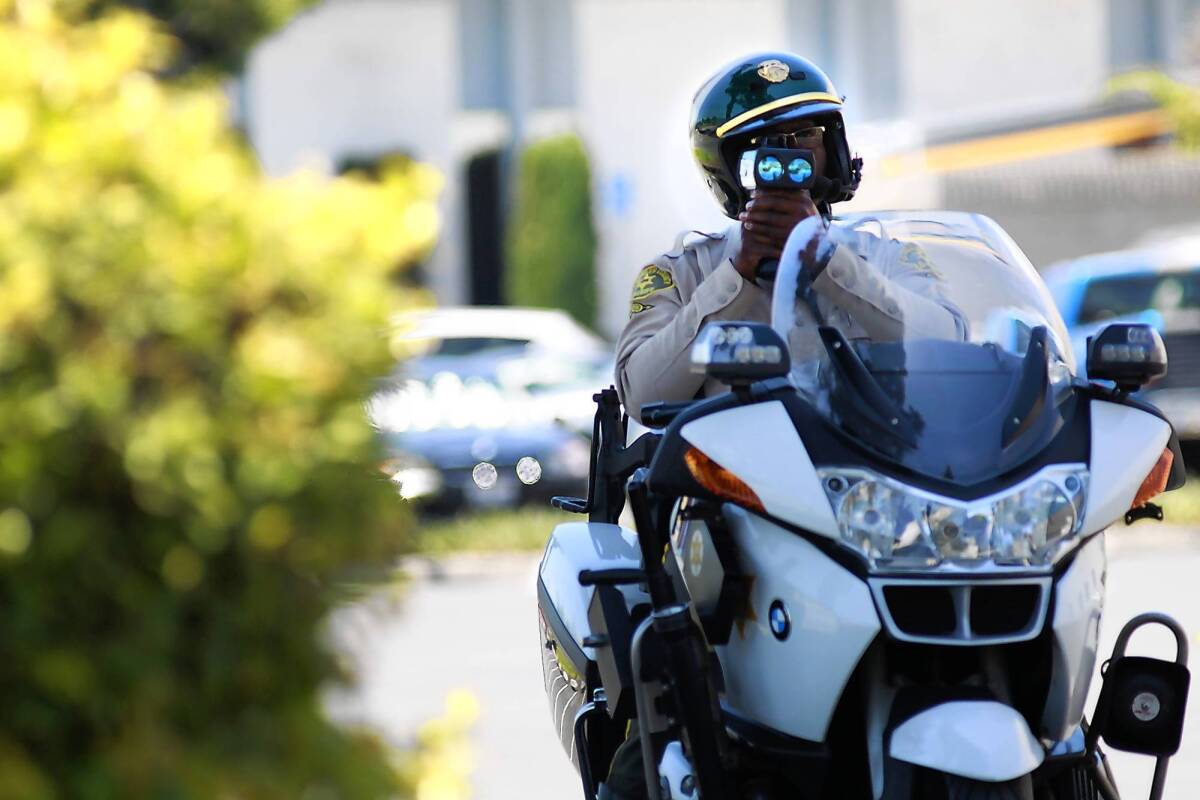 Los Angeles County Sheriff's Deputy Elton Simmons checks a motorist's speed in La Mirada.