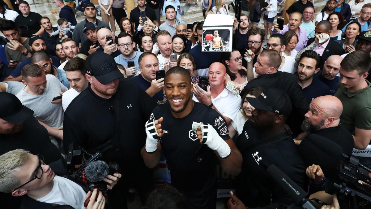 Anthony Joshua poses with fans after a session May 28 at Brookfield Place in New York.