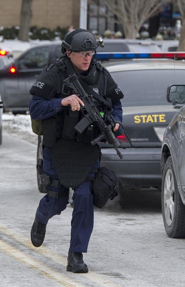A Maryland state police officer patrols outside The Mall in Columbia after a gunmen killed two people at the Maryland shopping center.
