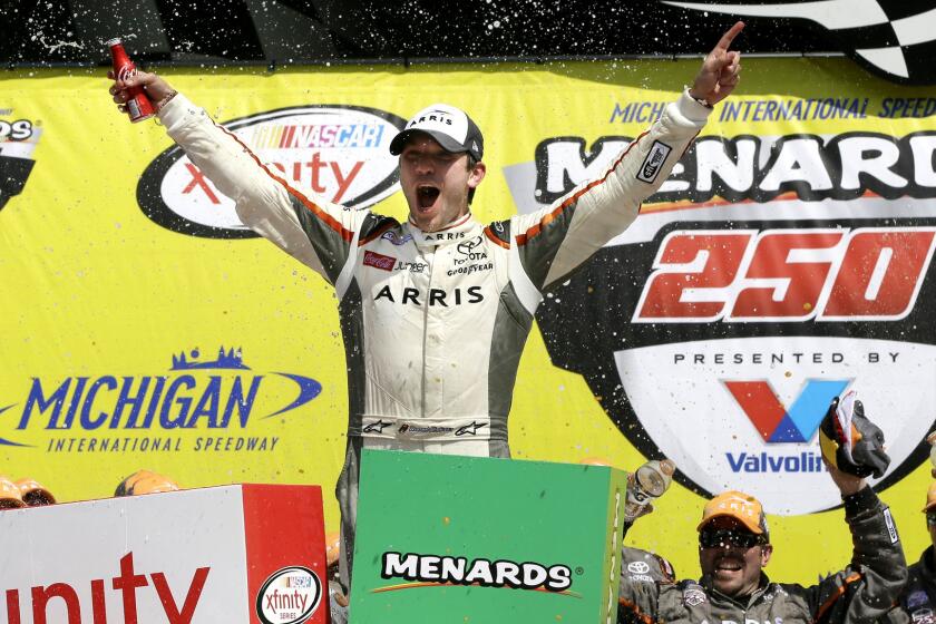 NASCAR driver Daniel Suarez celebrates after winning the Xfinity Series race Saturday at Michigan International Speedway.
