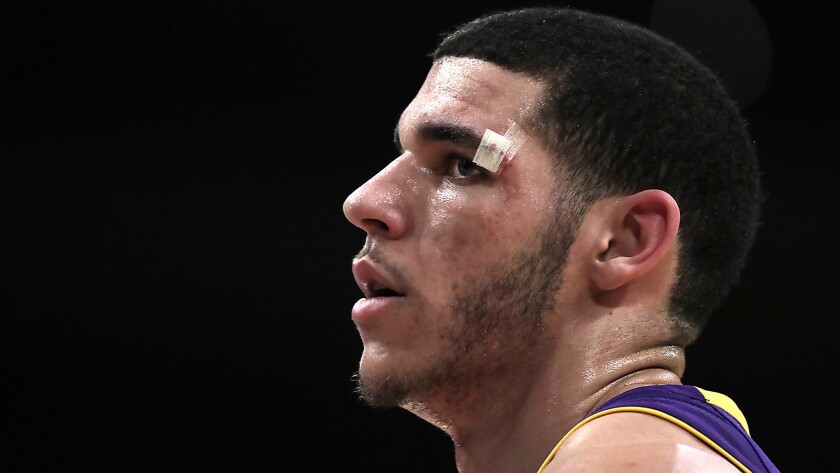 Bloodied by a scramble on the floor, Lakers guard Lonzo Ball catches his breath during a break in the action.