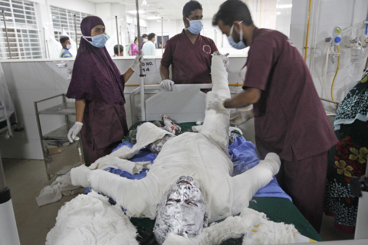 Doctors treat a patient in Dhaka, Bangladesh.