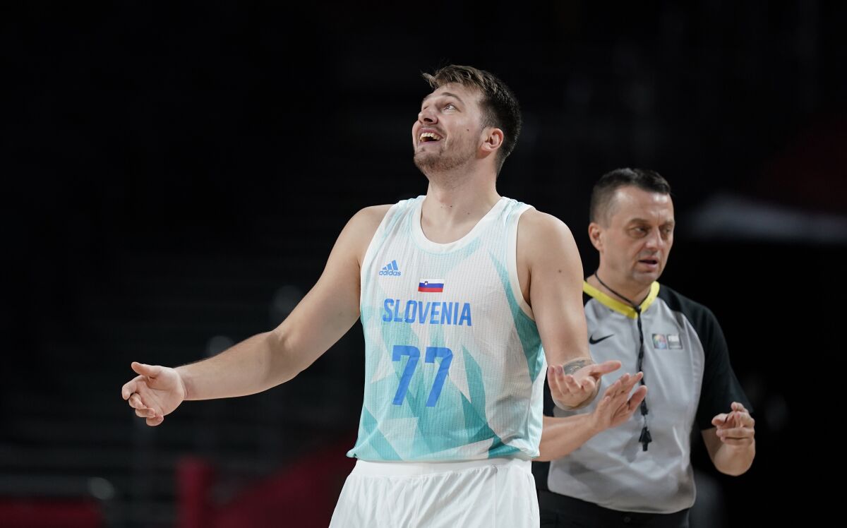 Slovenia's Luka Doncic (77) reacts to a foul call during men's basketball quarterfinal game against Germany at the 2020 Summer Olympics, Tuesday, Aug. 3, 2021, in Saitama, Japan. (AP Photo/Charlie Neibergall)