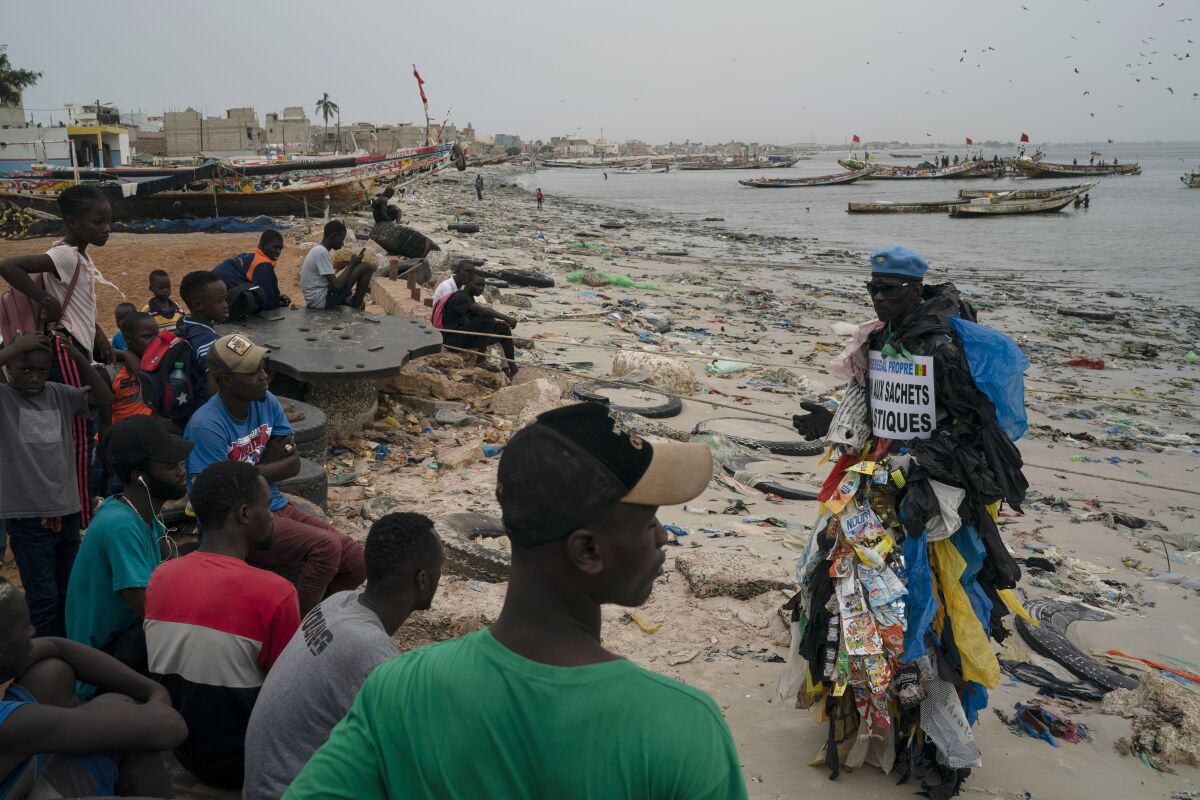 Modou Fall talks to the locals about the pollution caused by plastic bags.
