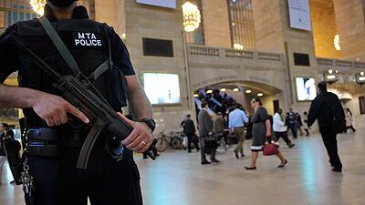 An armed Metropolitan Transportation Authority police officer stands guard in New York's Grand Central Station.