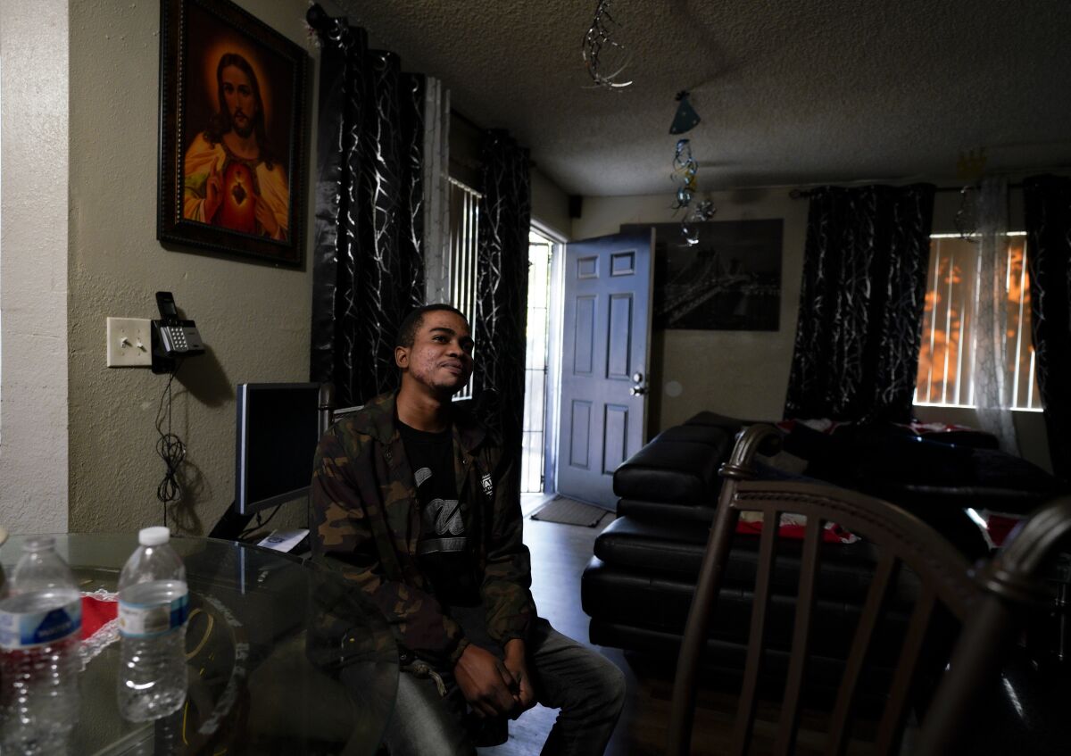 Patrick, 20, a refugee from the Democratic Republic of Congo, sits in his friend's apartment in Oak Park.