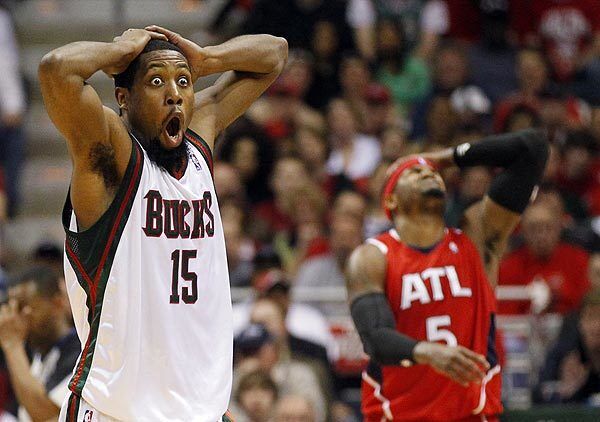 The Milwaukee Bucks' John Salmons and Atlanta Hawks' Josh Smith react to a call during the first half of Game 3 of the first round of the NBA playoffs.